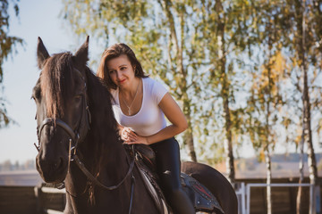 Rider elegant woman talking to her horse. Portrait of riding horse with woman . Equestrian horse with rider at nature 