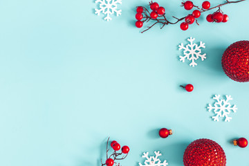 Christmas composition. Red balls, snowflakes on blue background. Christmas, winter, new year concept. Flat lay, top view, copy space