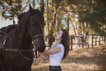 Obraz premium Rider elegant woman talking to her horse. Portrait of riding horse with woman . Equestrian horse with rider at nature 