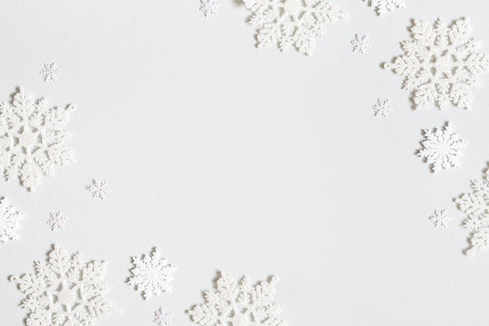 Christmas composition. Frame made of snowflakes on pastel gray background. Christmas, winter, new year concept. Flat lay, top view, copy space