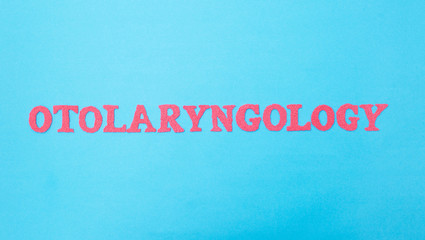 Fototapeta na wymiar The word otolaryngology on a blue background. Concept is a section of medicine dealing with the treatment of the ear, throat and nose. ENT doctor