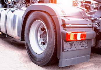 The back of a modern European cargo delivery truck. Logistics and freight concept, background, wheel