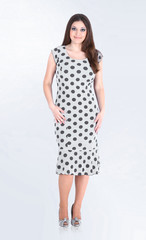 in full growth. beautiful young woman in white dress with blue polka dots