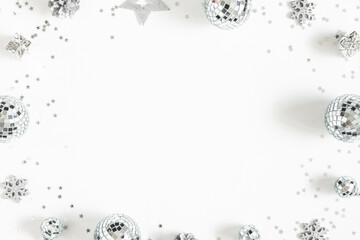 Christmas composition. Frame made of christmas silver decorations on white background. Flat lay, top view, copy space