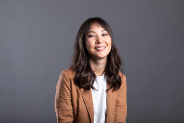 Young friendly asian woman with smiley face isolated.