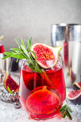 Fig autumn alcohol cocktail with cognac or liquor, rosemary, figs and honey, white marble table, with bar tools, copy space