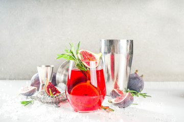 Fig autumn alcohol cocktail with cognac or liquor, rosemary, figs and honey, white marble table, with bar tools, copy space