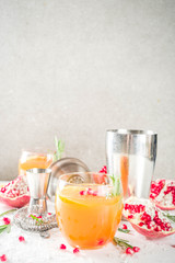 Orange and rosemary fizz with cider. Christmas festive mocktail. Autumn winter alcohol fruit and berry drink. White marble background with bar tools. Copy space