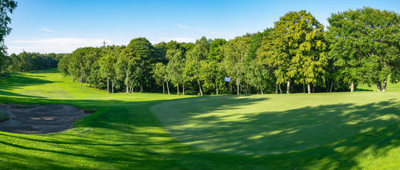 Panorama View of Golf Course with beautiful putting green. Golf course with a rich green turf beautiful scenery.