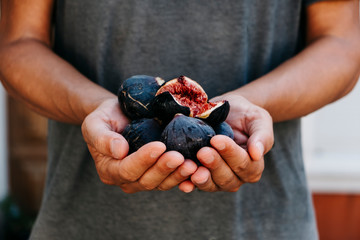 man with some figs in his hands