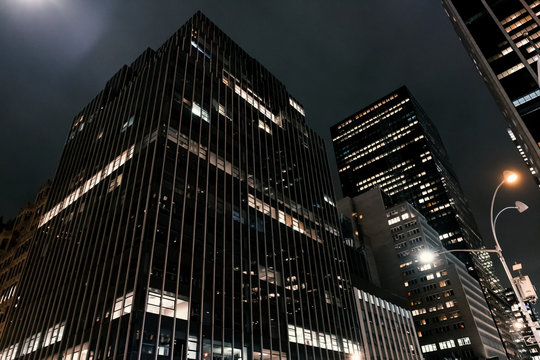 skyscrapers at night in new york manhattan office corporate commercial skyline palace hotel high downtown buildings hall windows office windows night photography