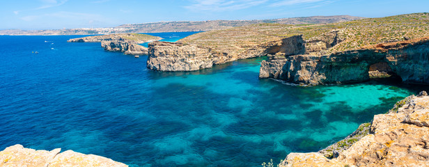 Stone cliffs on the blue lagoon of the island of Comino and Gozo Malta. Mediterranean Sea