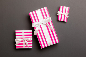 wrapped Christmas or other holiday handmade present in paper with White ribbon on black background....