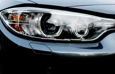 Modern, xenon based headlight cluster seen on a modern, German manufactured sports car at a...