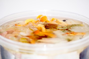 Pickled herring in a jar closeup.