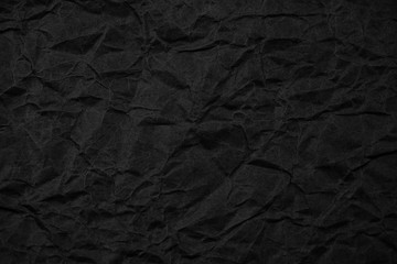 Black crumpled packaging paper background texture. Dark Kraft Paper Coarse. Wrinkled paper bag