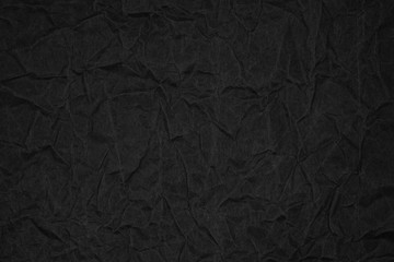 Black crumpled packaging paper background texture. Dark Kraft Paper Coarse. Wrinkled paper bag