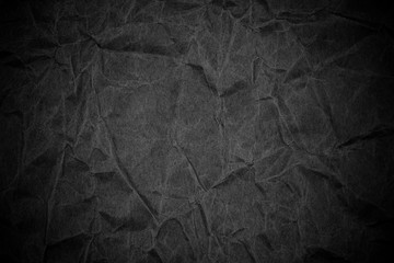 Black crumpled packaging paper background texture. Dark Kraft Paper Coarse. Wrinkled paper bag