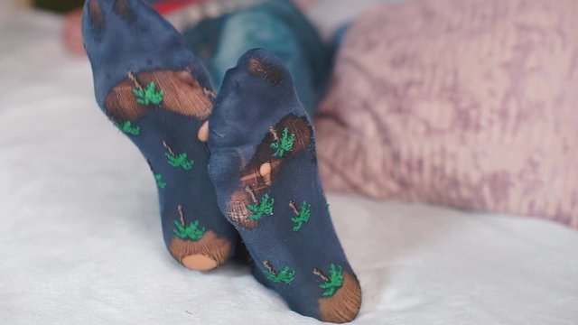 Closeup of leaky socks on the legs of a businessman.