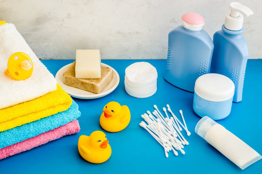 Bathroom accessories set with rubber dck on blue background