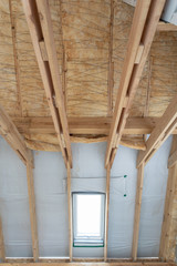 House under construction with insulation glass wool on an attic floor