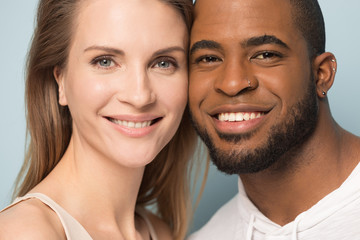 Portrait of smiling multiracial couple look at camera cuddling