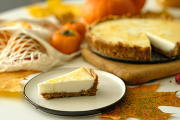 pumpkin cheesecake with persimmon. autumn concept.