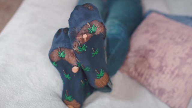 Men's feet wearing old socks