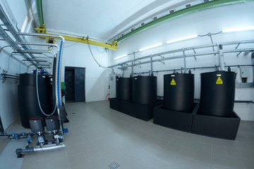 At the dosing systems hall of the water pumping station: sodium hypochlorite storage tanks and...