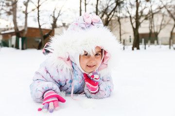 Portrait of a little girl smiling in the snow