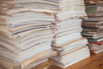 Large stacks of office paper sheets of documents. Financial reports. Bookkeeping.