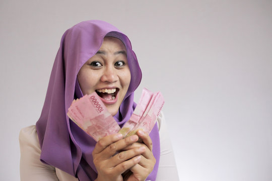 Indonesian Muslim Woman Holding Rupiah Money