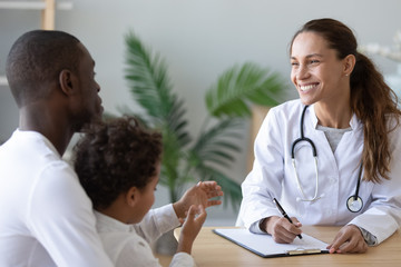 Smiling female doctor consulting african American dad with son