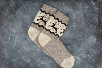 A pair of Christmas socks on grey background.