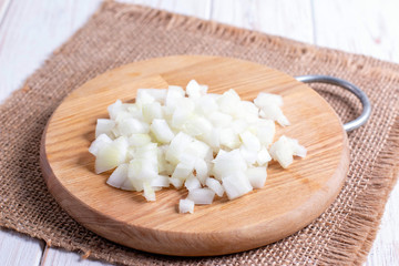 Sliced onion on a cutting wooden board