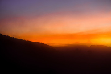 Mountains and skies before sunrise in the morning are covered by a lot of mist.