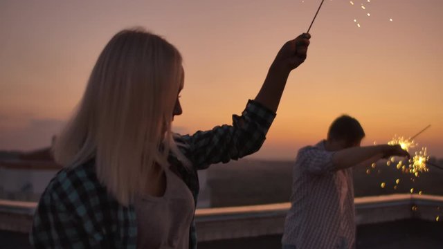 Girl raises her hands up and dancing with bangal light