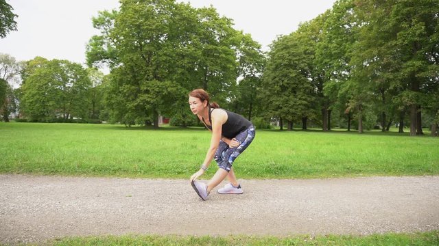 young, fit and sporty woman exercising in green park
