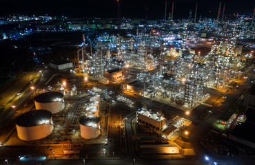 Aerial view oil storage tank with oil refinery factory industrial. Oil refinery plant at night....