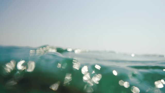 sea waves and underwater view with sunrays shining through the water
