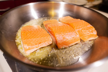 Salmon steak. Raw meat. Mediterranean diet. Cooking in a restaurant. Fried sea fish. Organic food. Side dish of vegetables and cream sauce