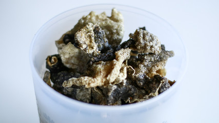 Fish skin crackers on white background. Made from patin fish. 