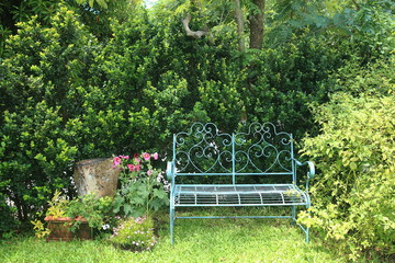 Metal bench of blue in english garden style.