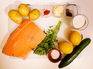 Salmon steak. Raw meat. Mediterranean diet. Cooking in a restaurant. Fried sea fish. Organic food. Side dish of vegetables and cream sauce