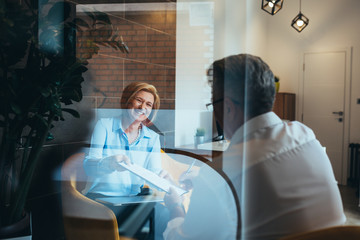 man signing contract in modern office