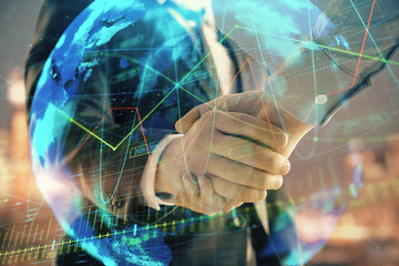 Double exposure of financial chart and world map on cityscape background with two businessmen...