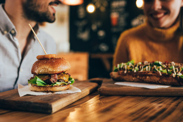couple having fun eating in food corner bar