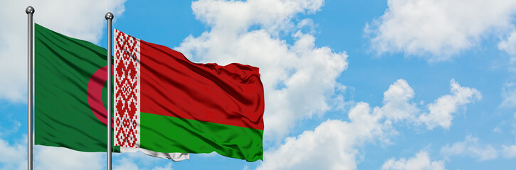Algeria and Belarus flag waving in the wind against white cloudy blue sky together. Diplomacy concept, international relations.