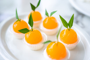 Orange jellies are decorated on a plate of orange-like characteristics. Has a sweet and sour taste