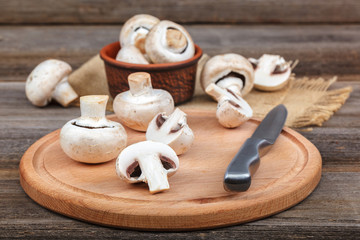 Fototapeta na wymiar Fresh fruits of mushrooms on a wooden board